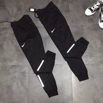 Nike耐克褲子男褲2019新款反光加絨保暖運動褲寬松束腿小腳衛褲長