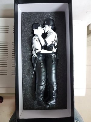 Mighty Jaxx Kissing Coppers by Banksy