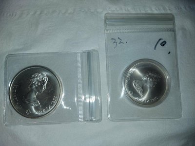 加拿大1976年蒙特婁奧林匹克運動會紀念銀幣( 重48.6g)＋5Dollars紀念銀幣(重24.3g)都是純925銀；總共2枚出售｛重48.6克邊角略微氧化｝
